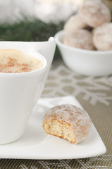 Сup of cappuccino and a Christmas gingerbread on a plate select