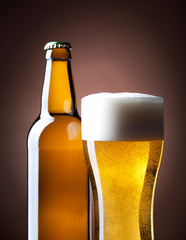 beer glass and bottle on a brown