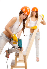 Gemini girls  with an electric drill on a white background.