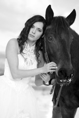 Bride with a horse in the snow