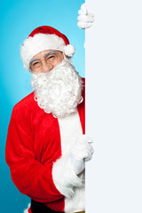 Santa posing beside long blank banner ad