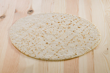 Pita bread on kitchen wooden plank