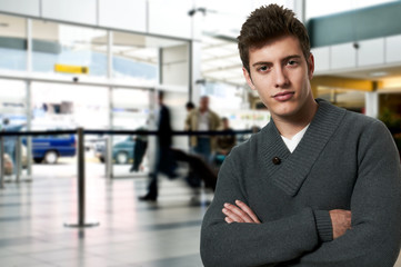 Young man traveling standing at the airport