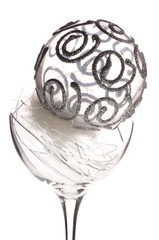 Silver Christmas ball in broken glass