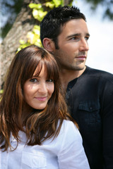 Fototapeta premium Couple embraced near a tree