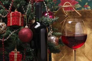 glass of red wine on the and christmas tree