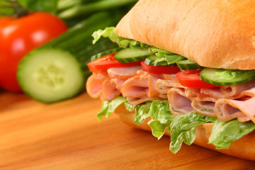 Fresh ham sandwich on wooden board