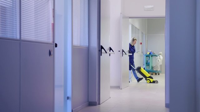 Women at workplace, professional cleaner washing floor in office