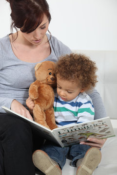 A mother reading to her son.
