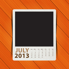 Calendar 2013, blank photo on wooden background.