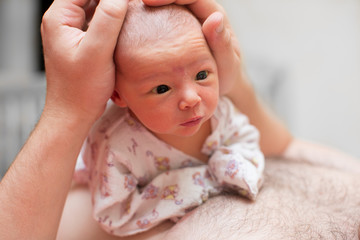 Newborn baby in the hands of the dad