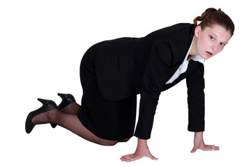A businesswoman on all fours.