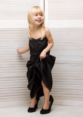 Girl 3 years old in mother's dress and high heels