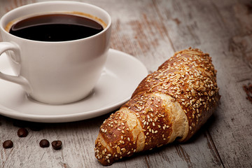 cup of black coffee and croissant