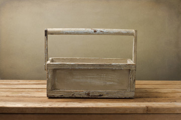 Wooden box on wooden table over grunge background
