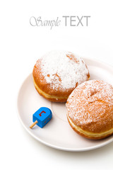 Donut with dreidel on plate. Hanukkah holiday.
