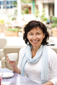 Cute young woman with a cup of coffe
