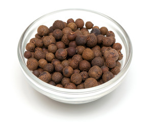 whole allspice berries in a glass bowl