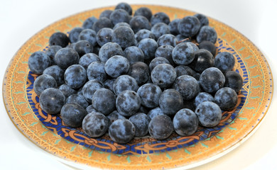 blue berries on the gold saucer