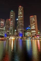 Zelfklevend Fotobehang Night lights and skyscrapers' reflections in Singapore © tuomaslehtinen