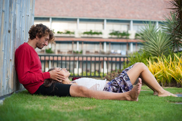 loving couple resting the lawn at the hotel Spa