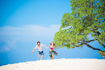 loving couple resting on the beach in the sand on the island of Bali.