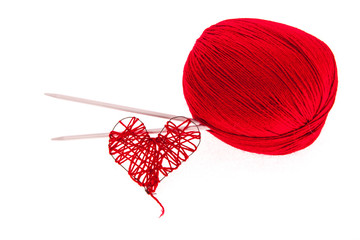 Knitting yarn with needles and a heart