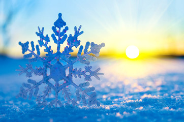 Decorative snowflake against the setting sun