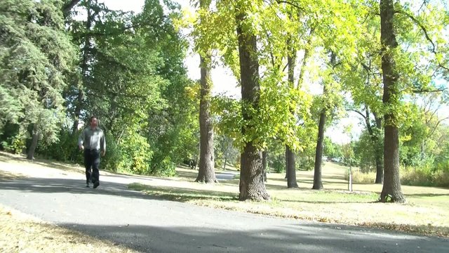 Man Walking Through Park