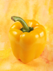 Fresh yellow paprika on yellow background