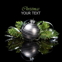 Christmas ornament with pine tree branches on a black background