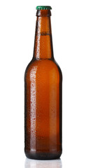 Brown bottle of beer with drops on white