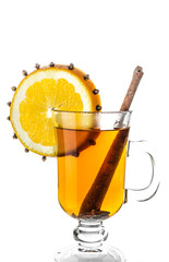 Warm drink with slice of orange, cinnamon and cloves