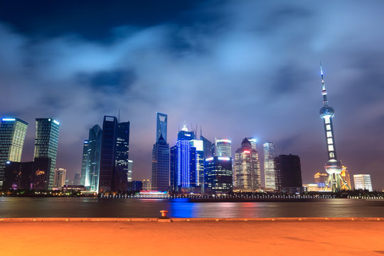 shanghai skyline with pier at night