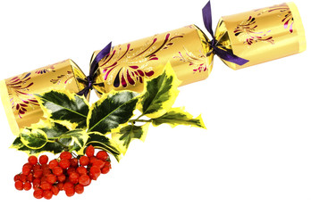 Ivy, red winter berries and golden, ornate Christmas cracker