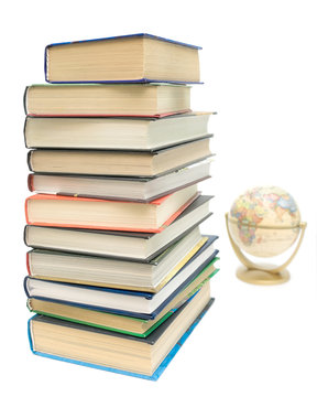 stack of books and a globe on a white background