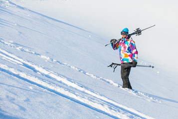 Young man with skis and a ski wear