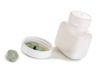 Dispenser for tablets with bottle with pills isolated on white