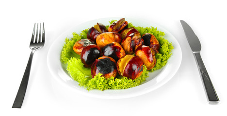 roasted chestnuts with lettuce in the white plate with fork and