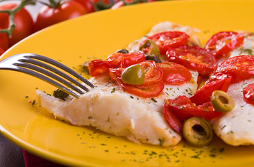 Fish with cherry tomatoes and olive.