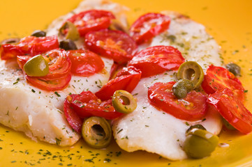 Fish with cherry tomatoes and olive.