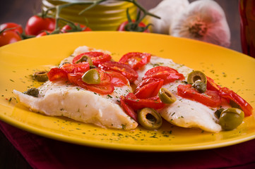 Fish with cherry tomatoes and olive.