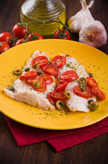 Fish with cherry tomatoes and olive.