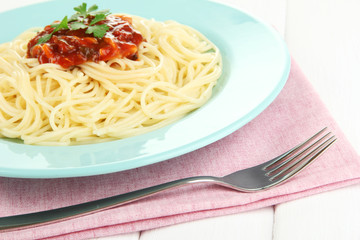 Italian spaghetti in plate on wooden table