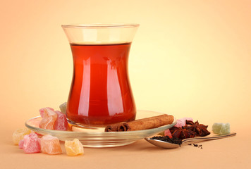 glass of Turkish tea and rahat Delight, on beige background
