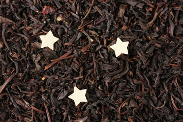 aromatic black dry tea with chocolate stars, close up