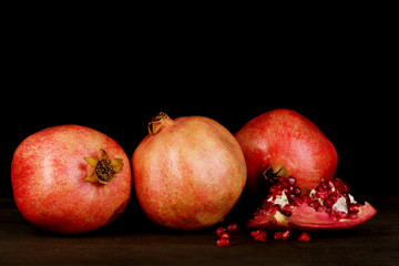 Ripe pomegranates isolated on black