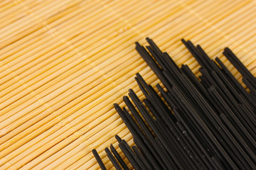 Black spaghetti on light background