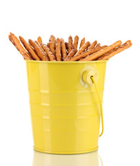 Tasty crispy sticks in yellow pail isolated on white