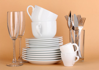 Clean white dishes on beige background